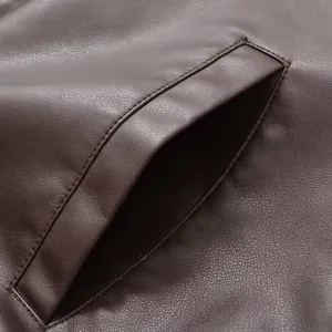 Close-up detail of a vintage brown faux leather jacket showing high-quality pocket stitching