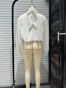 Detailed back view of a white long-sleeved blouse with a stylish bow tie at the neck