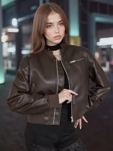 Close-up of vintage brown faux leather bomber jacket with ribbed cuffs and collar