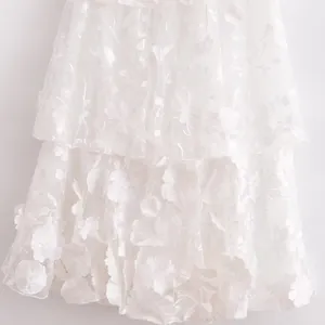 Exquisite close-up of white 3D floral embroidery on elegant summer luxury party dress