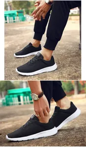 Detailed side view of lightweight black mesh running shoes worn by a model outdoors
