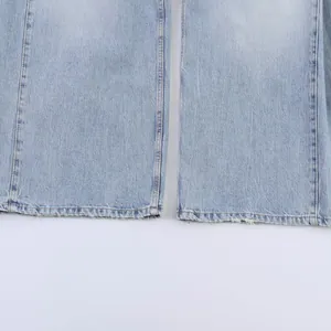 Close-up of the raw hem and stitching on light wash straight-leg denim jeans