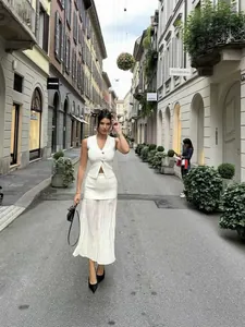 Chic white knit vest with gold buttons and matching pleated midi skirt two-piece set