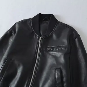 Detailed close-up view of black faux leather bomber jacket with ribbed collar and zip
