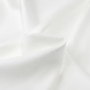 Macro view of luxurious white silk satin fabric showing smooth texture and soft draping