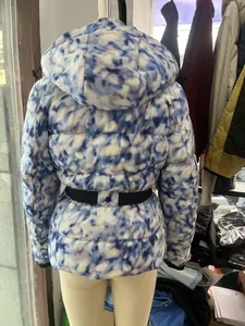 Back view of women's puffer ski jacket with blue marble pattern and hooded design