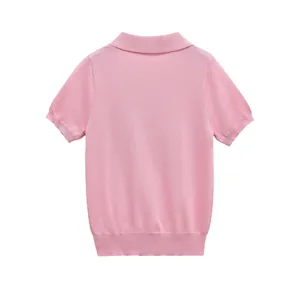 Detailed back view of a minimalist pink short-sleeved knitted polo shirt for women