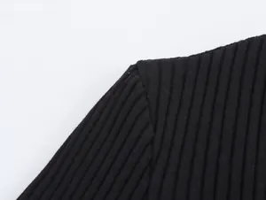 Detailed close-up view of the high-quality black ribbed knit fabric and shoulder seam