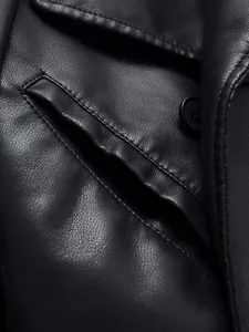 Macro shot of black faux leather jacket detail showing pocket and premium texture