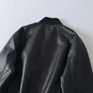 Close-up of the back view of a black faux leather bomber jacket with ribbed collar.
