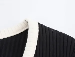 Detailed macro view showing the ribbed knit texture and contrast white trim of a sweater