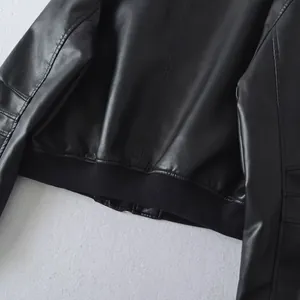 Close-up view of the ribbed hem and faux leather texture on a stylish black bomber jacket