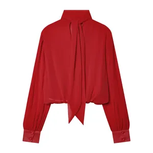 Detail view of elegant red long-sleeved blouse with a stylish back bow tie collar design.