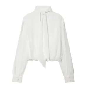 Detailed view of elegant white bow-neck blouse with stand collar and long sleeves