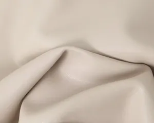 Gros plan détaillé montrant la texture grainée d'un tissu en similicuir crème souple