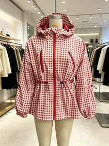 Front view of a red and white gingham hooded windbreaker jacket on a retail mannequin.