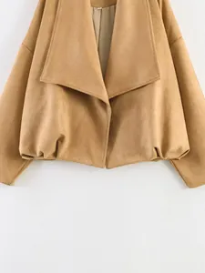 Detail view of khaki suede cropped jacket with oversized lapels and puffed hemline.