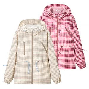 Macro view of women's vintage plaid hooded windbreaker in khaki and pink colors