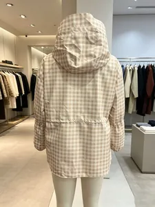 Detail view showing the back of a women's beige plaid hooded jacket with drawstring waist