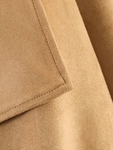 Close-up detail of khaki suede jacket showing premium stitching and soft fabric texture