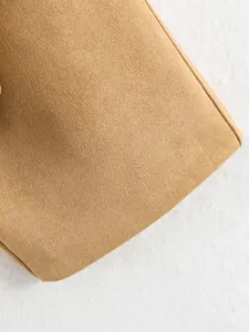 Close-up detail of khaki suede fabric texture on a casual loose-fit jacket