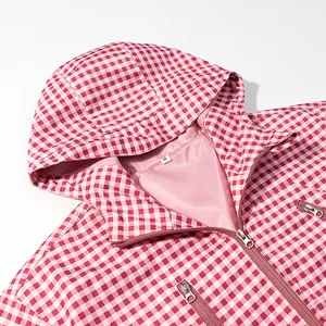 Detailed macro view of pink and white gingham checkered hooded windbreaker jacket