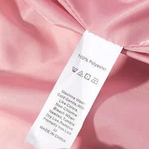 Detailed close-up showing the 100% polyester fabric care label on a pink jacket lining