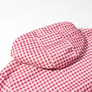 Close-up detail of the hood and red gingham pattern on a windproof spring jacket