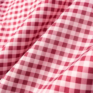 Close-up detail of red and white gingham fabric texture for a retro hooded jacket
