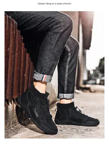 Close-up of black high-top winter boots for men in a casual outdoor setting