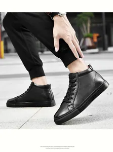 Dettaglio di sneaker alte in pelle nera con design stringato e suola in EVA