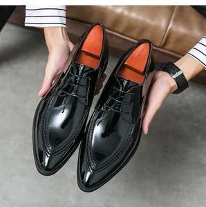 Detailed macro shot of black patent leather pointed toe dress shoes with elegant stitching