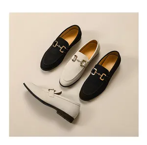 Close-up detail of stylish men's suede loafers featuring an elegant gold horsebit buckle