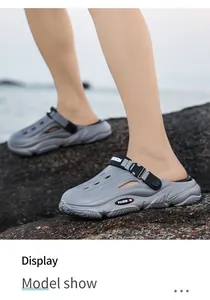 Stylish grey outdoor clogs for men featuring a breathable hollow design on a rocky beach