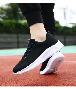 Side detail view of men's breathable black lightweight running shoes on an outdoor track