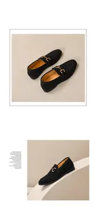 Macro view of black suede loafers with gold horsebit detailing on beige background