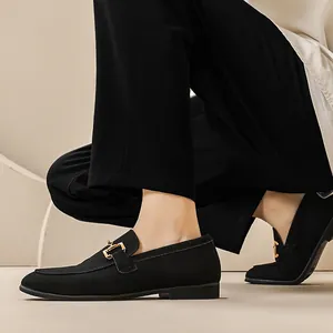 British style men's black suede loafers with gold buckle detail, minimalist slip-on design.