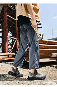 Vista lateral de zapatos de seguridad para hombre con malla transpirable y aire