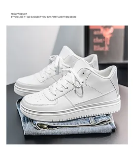 Stylish all-white high-top sneakers presented on folded blue denim jeans in a studio setting