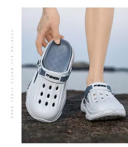 Detailed macro view showing breathable white outdoor clogs with FASHION branded straps