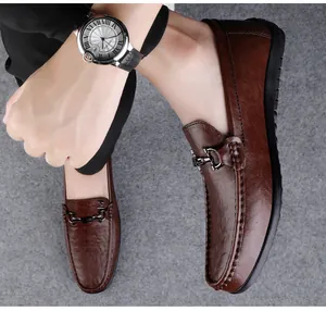 Classic brown leather loafers for men with stylish metal bit detail in a lifestyle shot