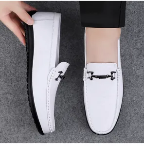 Close-up view of the white leather surface and black metal buckle on men's slip-on loafers