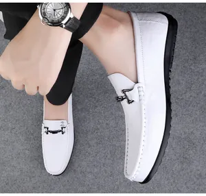 Close-up view of white leather loafers for men with stylish metal bit detail and soft sole
