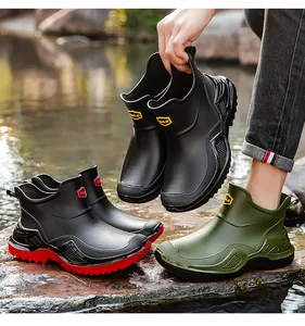 Outdoor detail showing men's waterproof short-cut rain boots with thick anti-slip soles