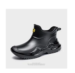 Side view of stylish black waterproof short rain boots with thick anti-slip soles