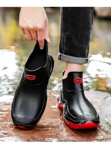 Detailed view of men's waterproof short rain boots with a durable thick red sole.
