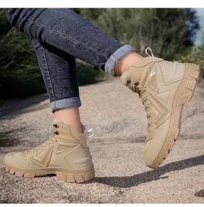 Outdoor action shot of men's khaki tactical hiking boots on a natural gravel path