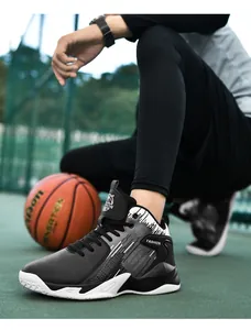 Close-up view of black and grey mid-top basketball shoes on an outdoor court setup