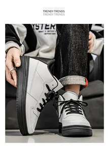 Detailed view of stylish white high-top sneakers with contrasting black soles and laces