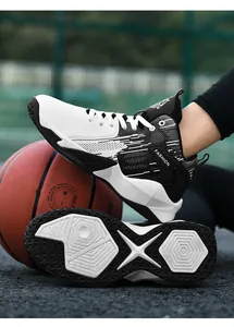Close-up of durable honeycomb outsole and side profile of black and white basketball shoes